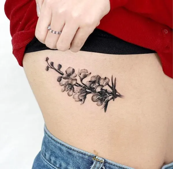 Delphinium rib tattoo for women by @myungdo___
