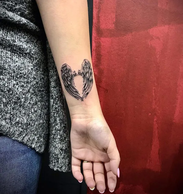 Angel wings tattoo on wrist 1