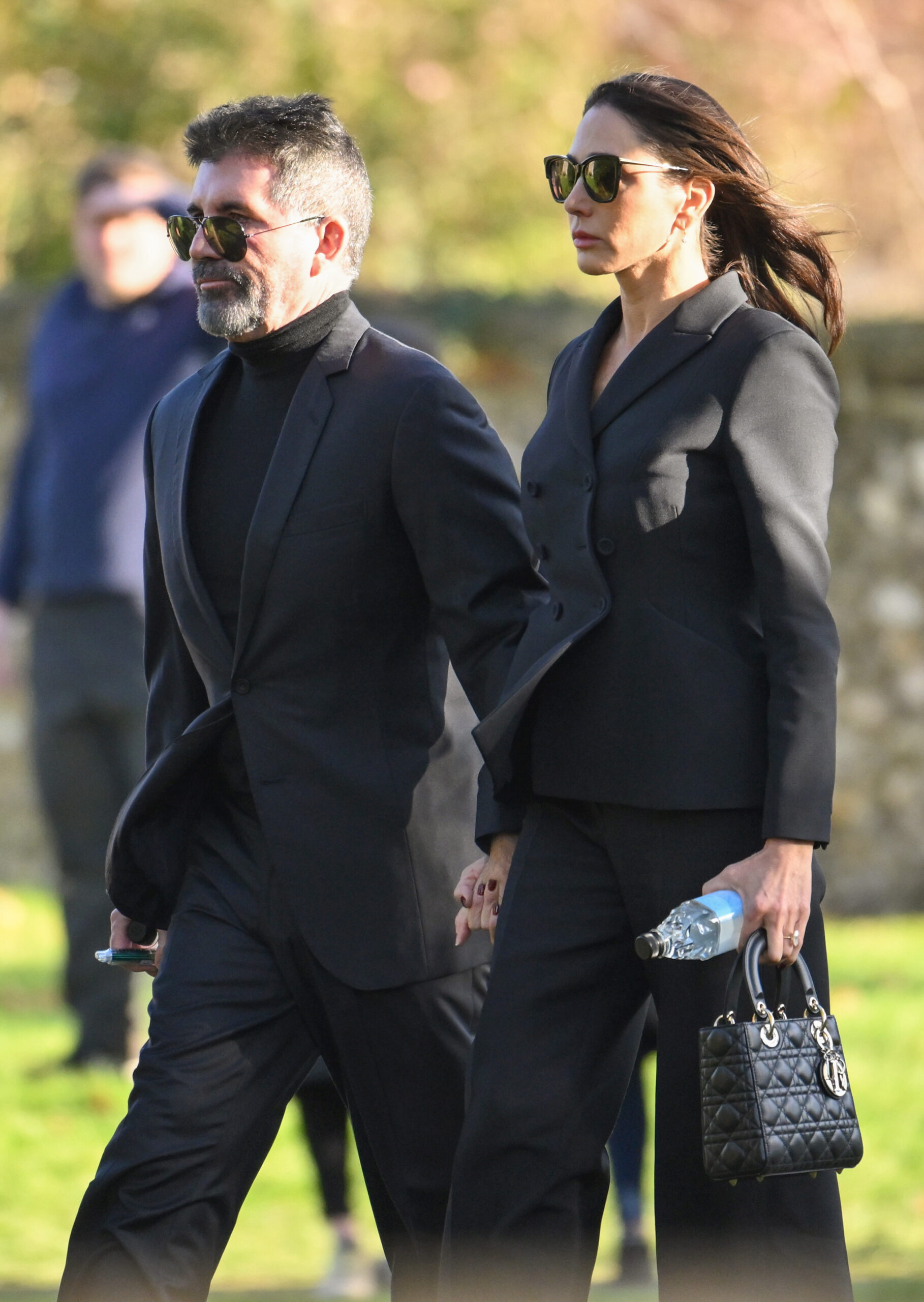 Simon Cowell and Lauren Silverman walking into Liam Payne's funeral