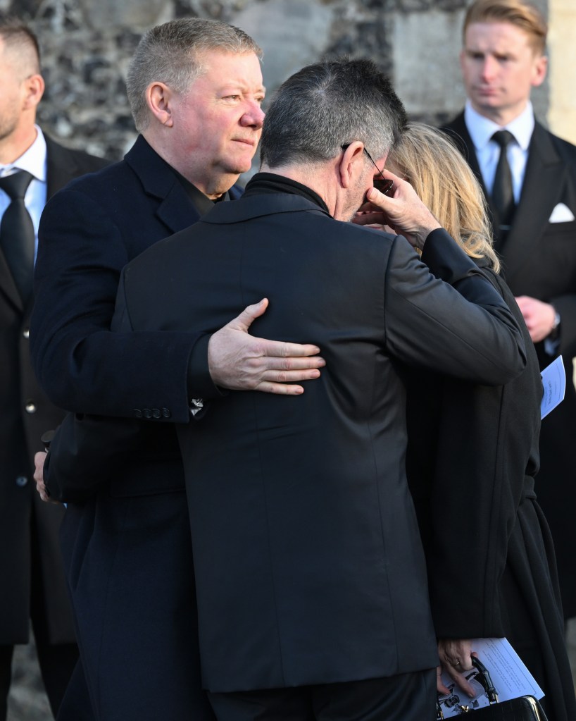 simon cowell hugging liam payne's parents at funeral