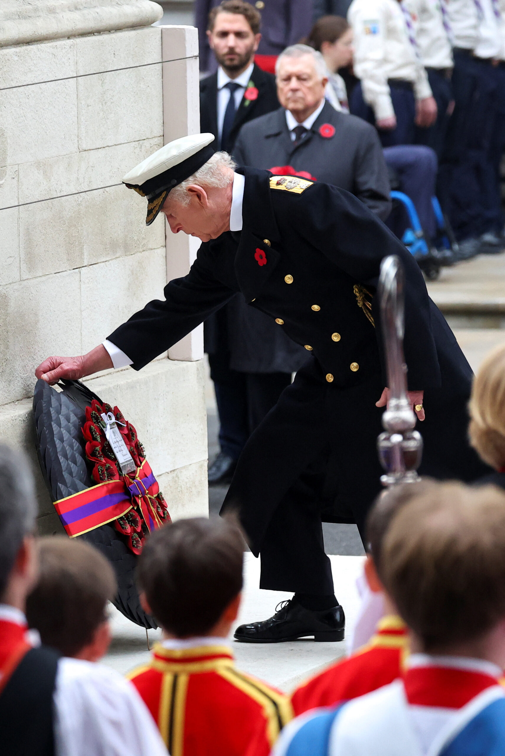 King Charles III laying a wreath down.