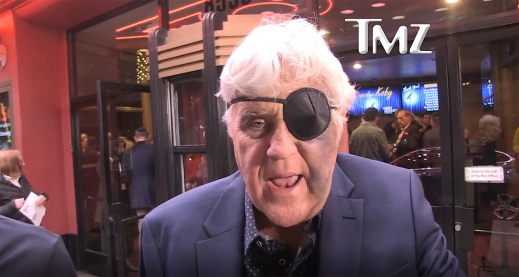 Jay Leno wearing an eyepatch with a bruise on his face.