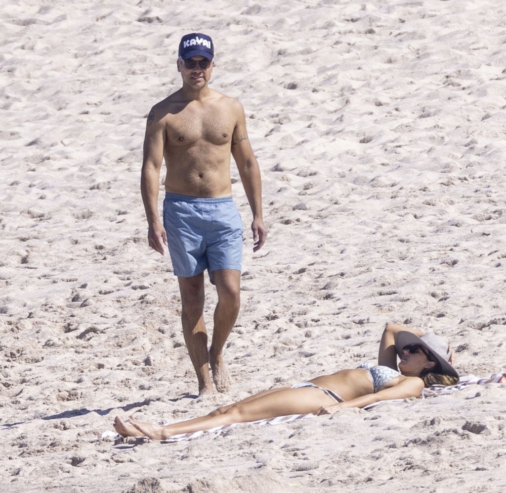 Jessica Alba lounges on the beach with her husband.