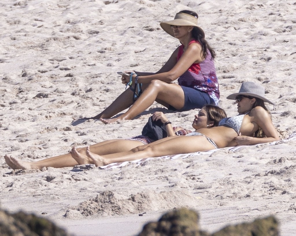 Jessica Alba lounging on the beach with her daughter.