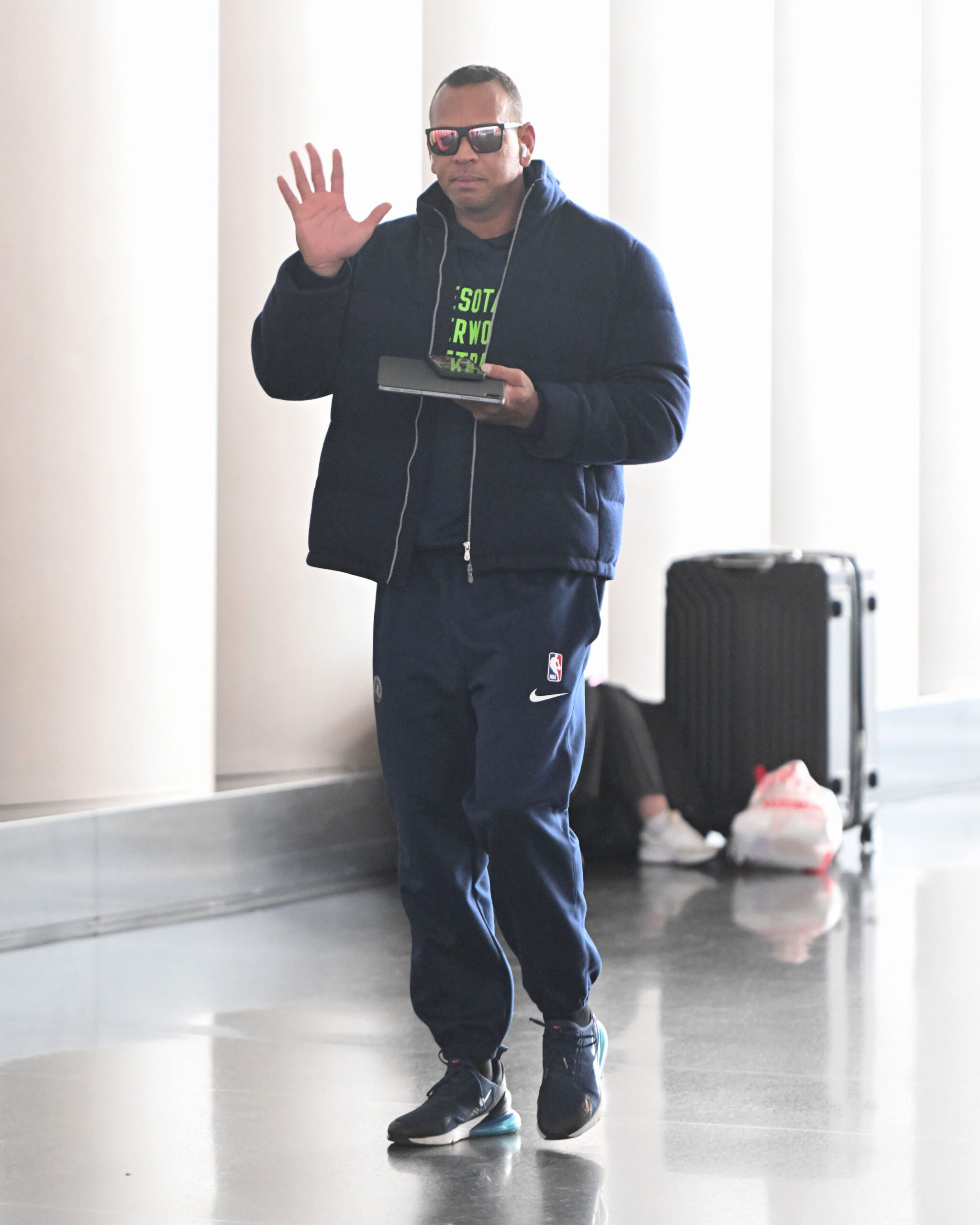 Alex Rodriguez gives a wave to the cameras while arriving at JFK in New York City.