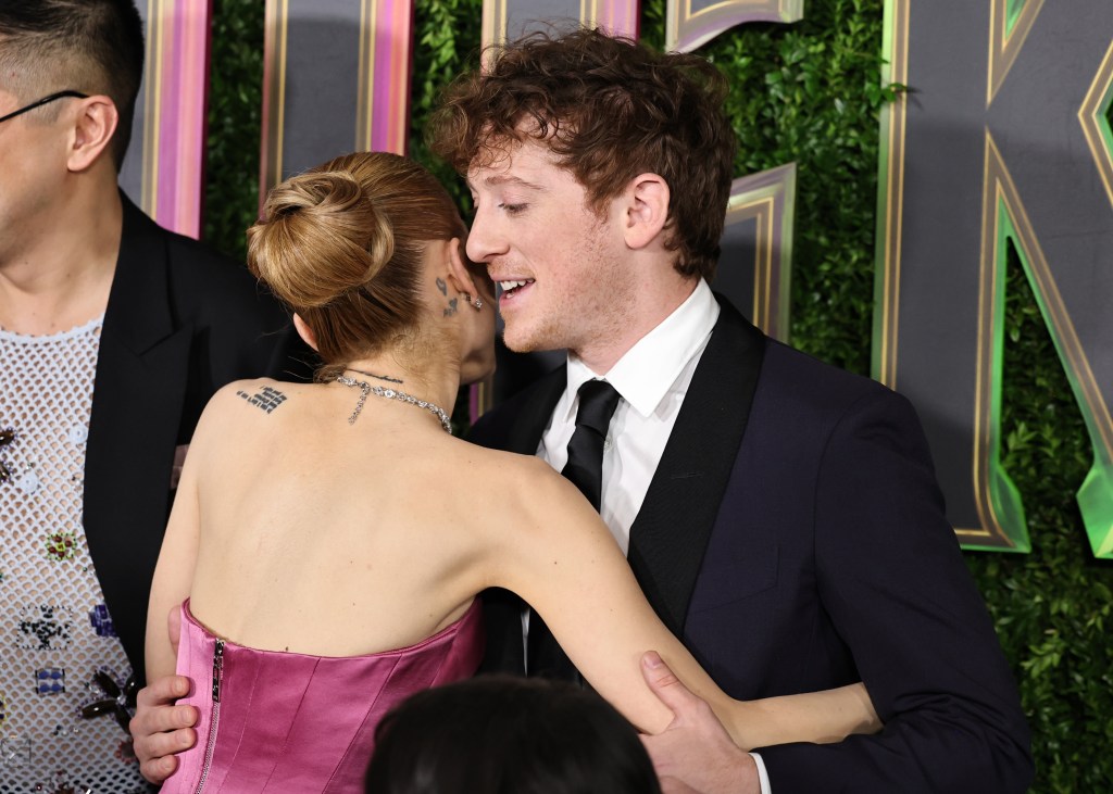 Ariana Grande and Ethan Slater hugging on the red carpet.