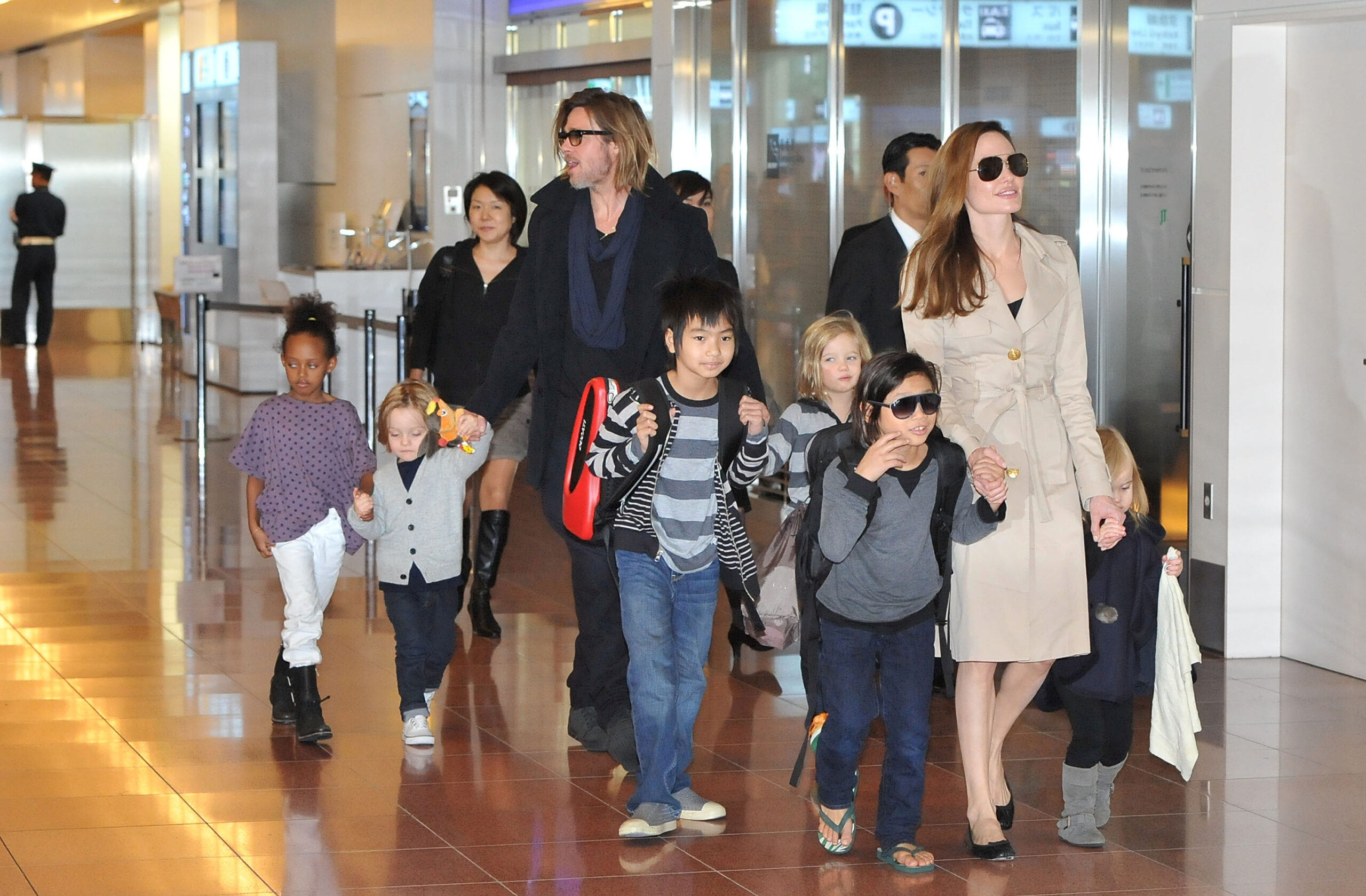 Angelina Jolie and Brad Pitt walking with their kids