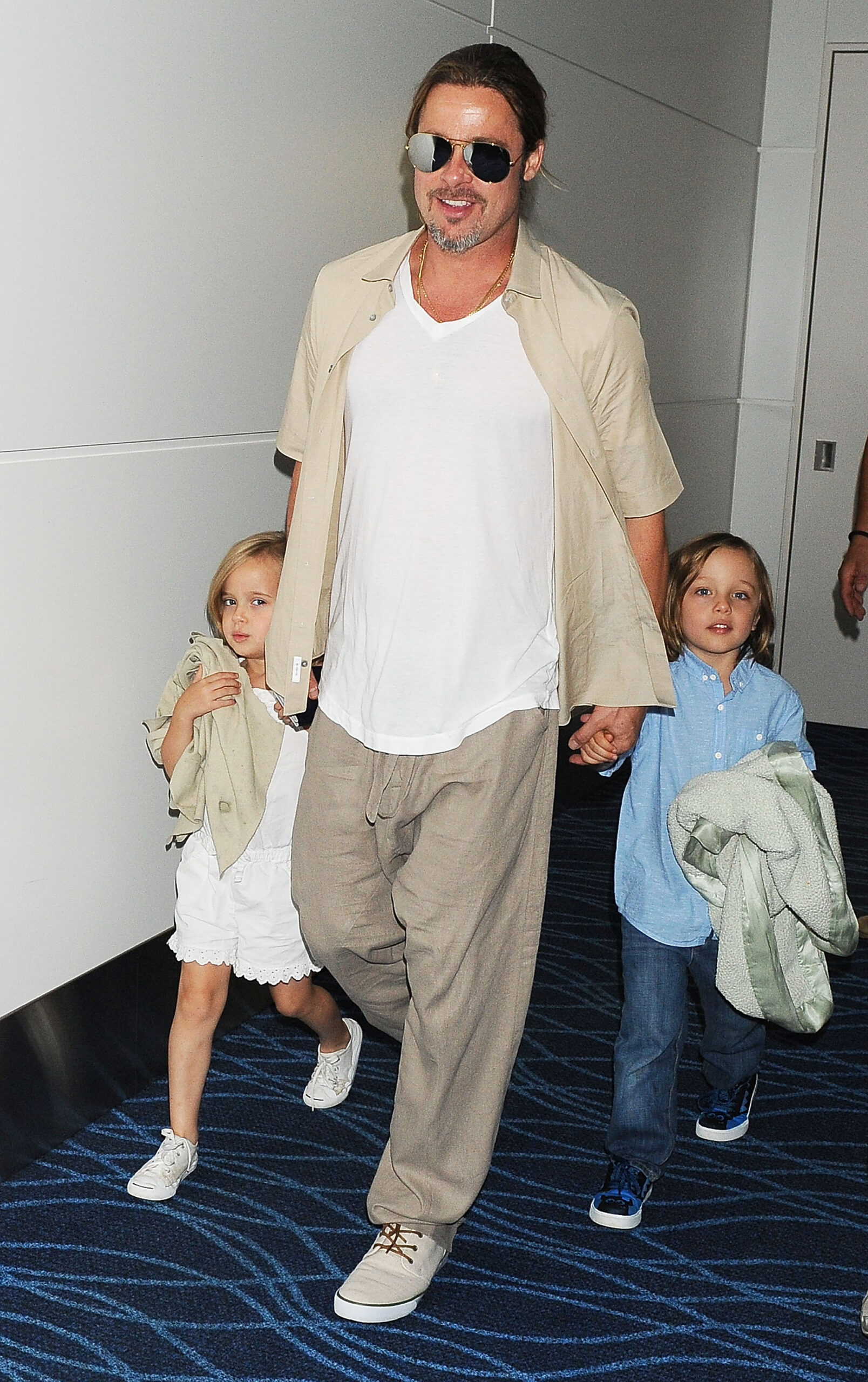 Brad Pitt walking with his kids in 2013