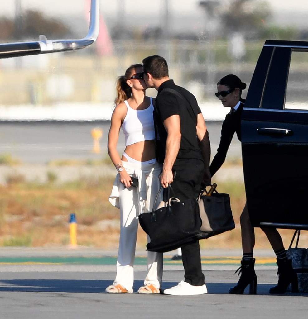 Brooks Nader and Gleb Savchenko pack on the PDA while boarding a private jet in Los Angeles on Oct. 9.