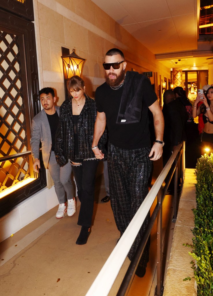 Taylor Swift and Travis Kelce holding hands on a date night.