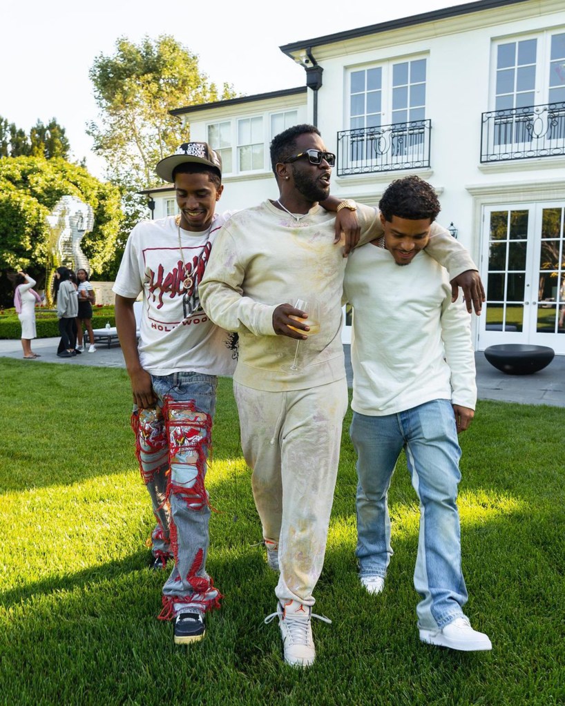 Sean "Diddy" Combs posing outdoors with his kids.