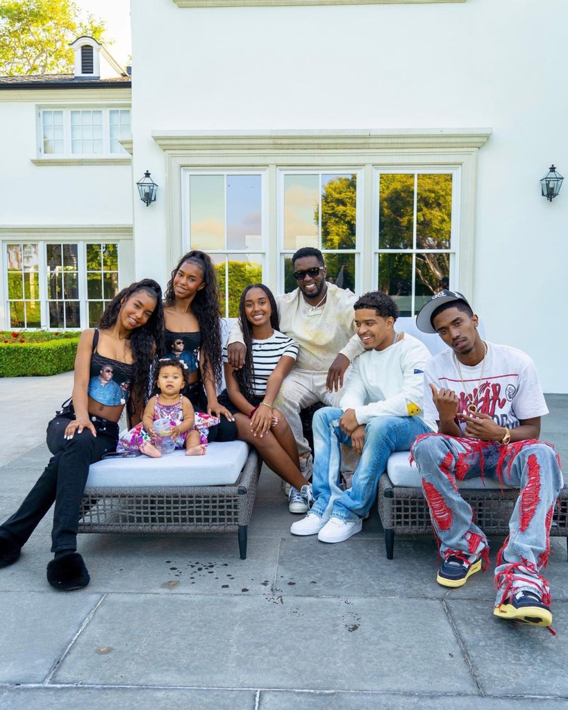 Sean "Diddy" Combs posing with all seven. of his children.