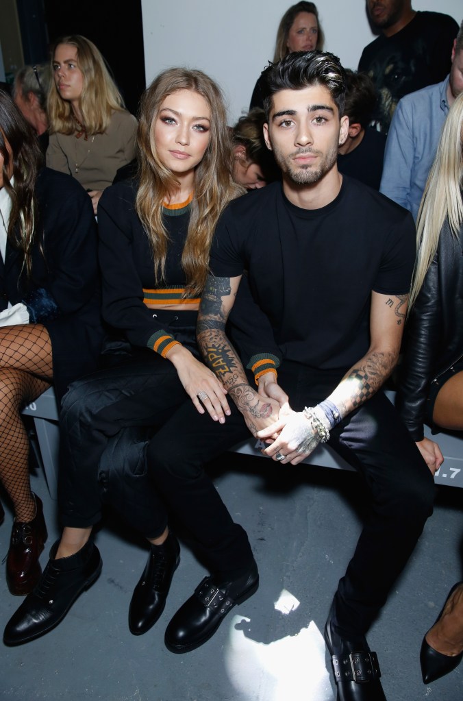 Gigi Hadid and Zayn Malik sit next to each other as they attend a fashion show.