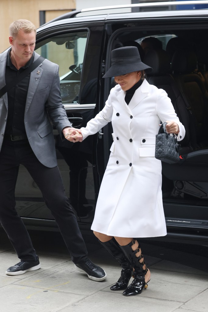 Jennifer Lopez being helped out of a car by her bodyguard in London