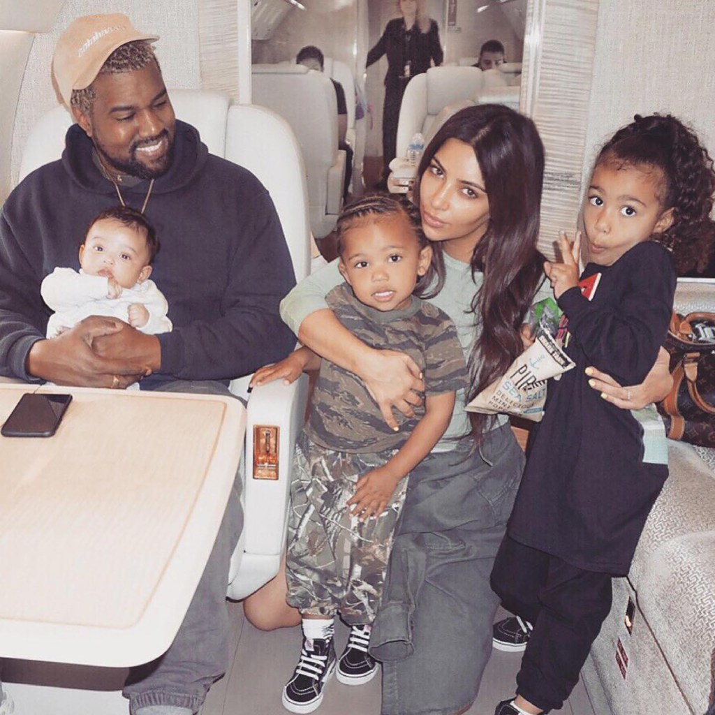 Kanye West and Kim Kardashian on a private jet with their kids.