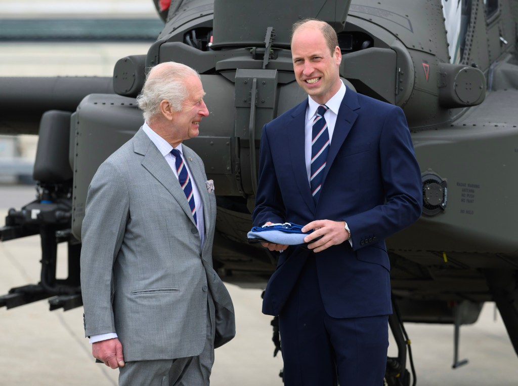 Prince William smiles with his father