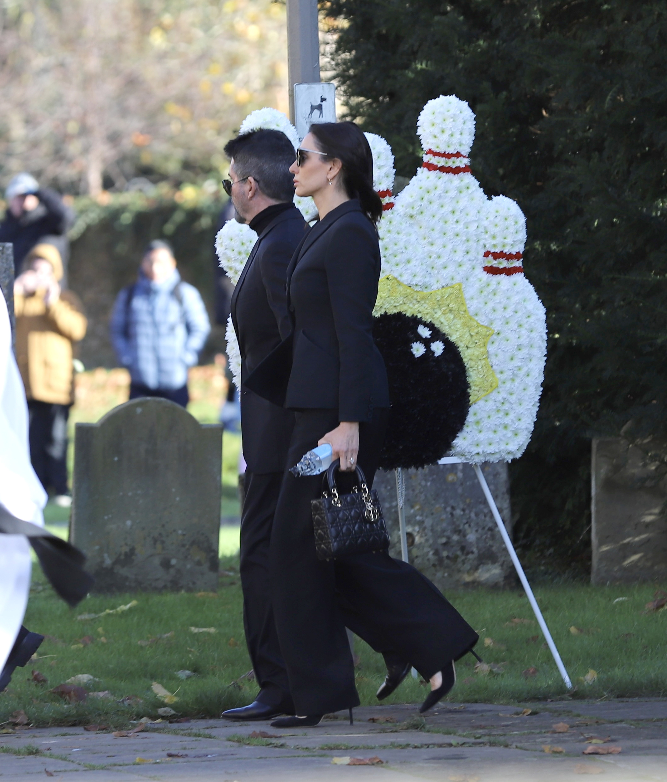 Simon Cowell and Lauren Silverman walking into Liam Payne's funeral