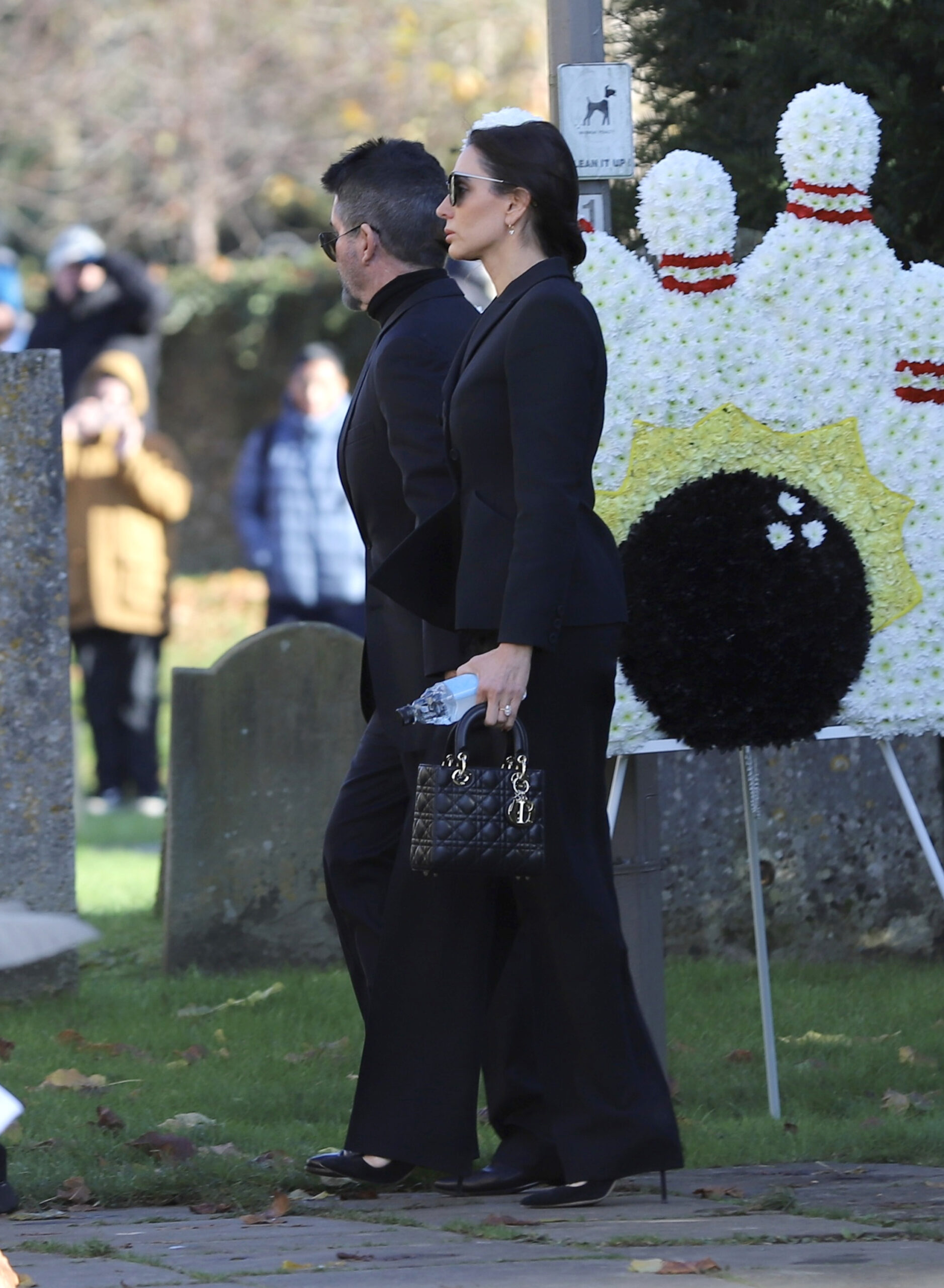 Simon Cowell and Lauren Silverman walking into Liam Payne's funeral