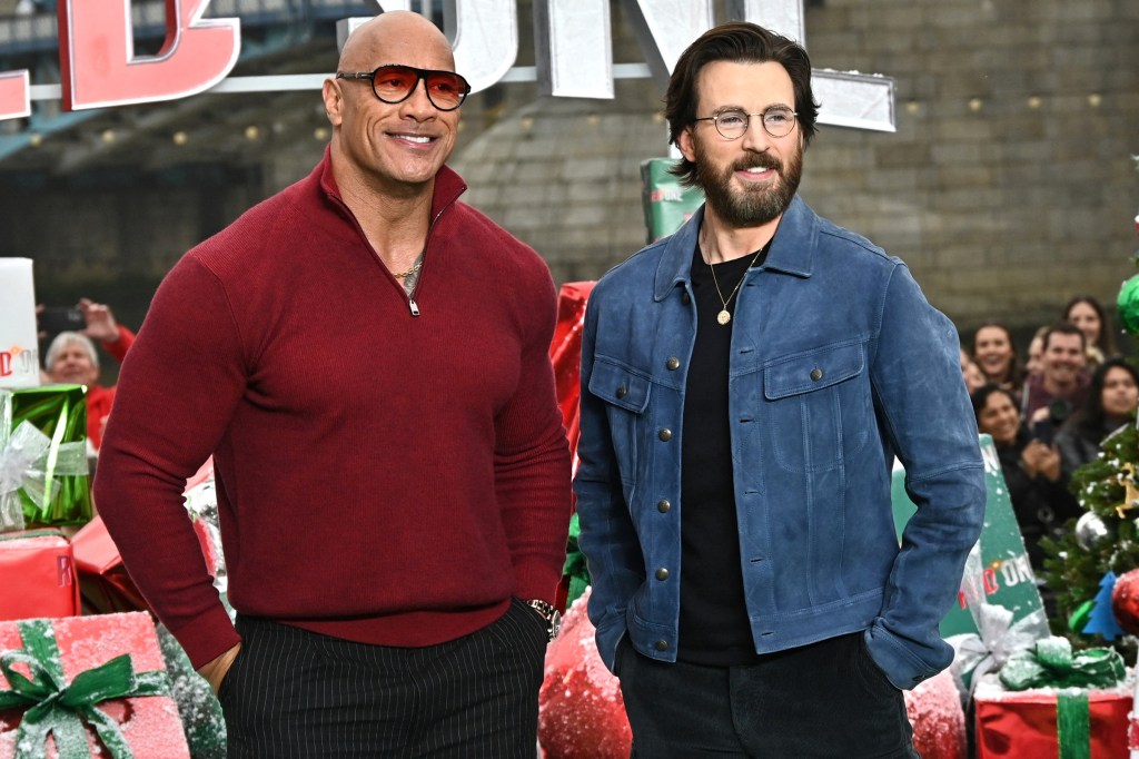 Dwayne Johnson and Chris Evans pose together at the "Red One" photo call.