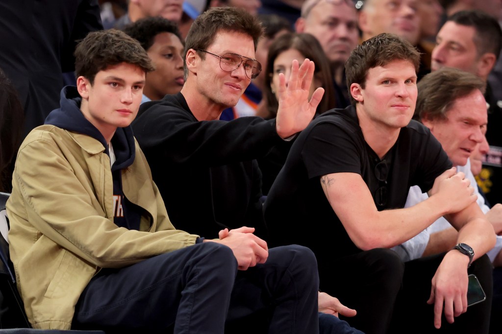 Tom Brady waves to fans during the third quarter between the New York Knicks and the Brooklyn Nets at Madison Square Garden.