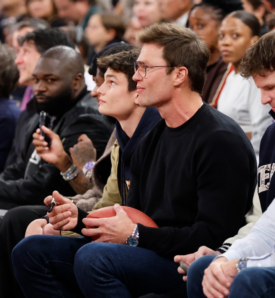 Tom Brady and his son sits court side during the third quarter between the New York Knicks and the Brooklyn Nets at Madison Square Garden.