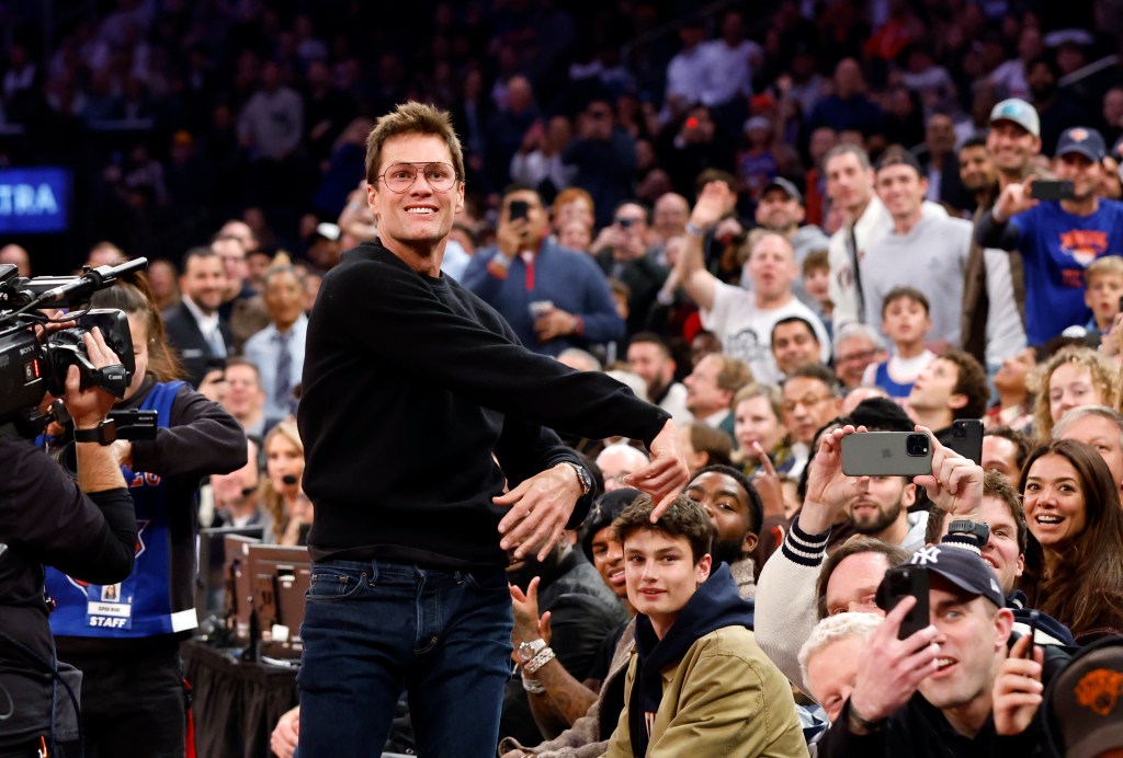 Tom Brady throws a football into the stands from celebrity row in the first half at the Madison Square Garden in New York on Friday.