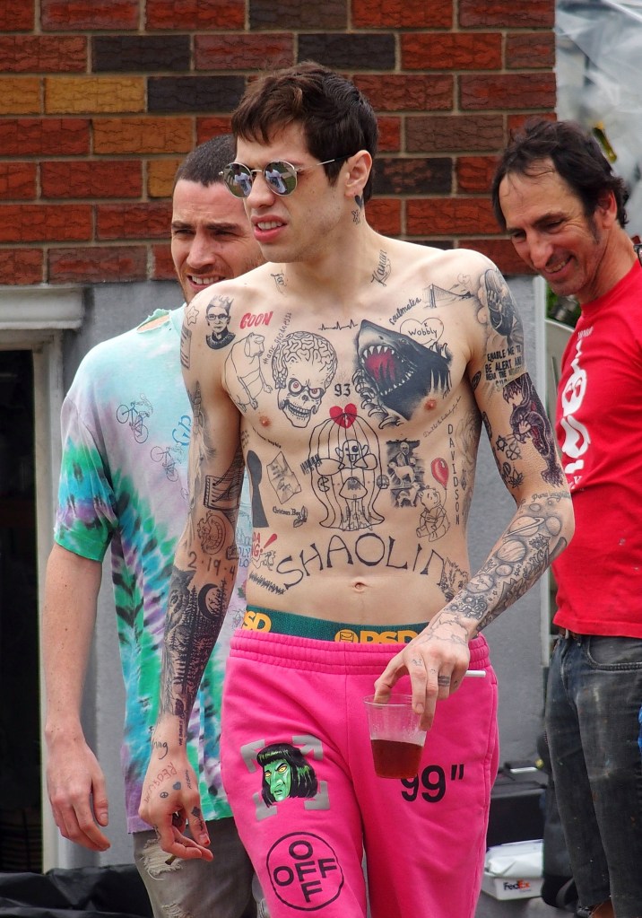 Pete Davidson showing off his intricate tattoos, including a giant shark on his chest, while on the set of an untitled project with Judd Apatow in New York City