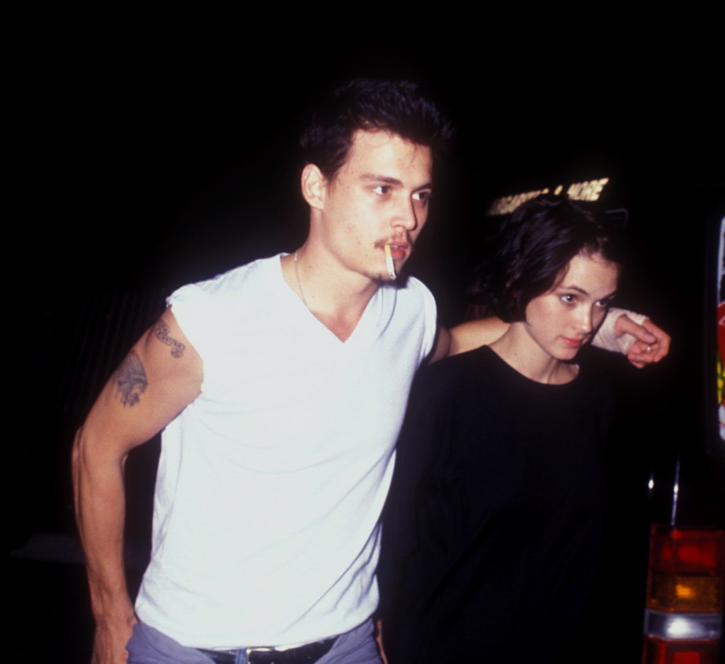 Johnny Depp and Winona Ryder walking together at Herb Ritts Birthday Party in Los Angeles, 1990