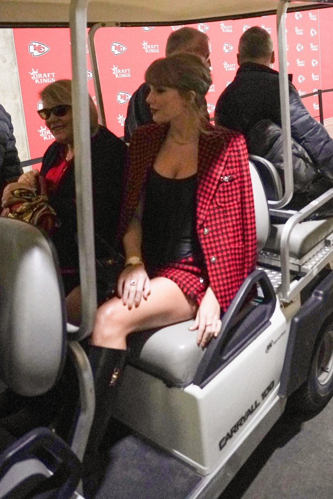 Taylor Swift sits in a golf cart