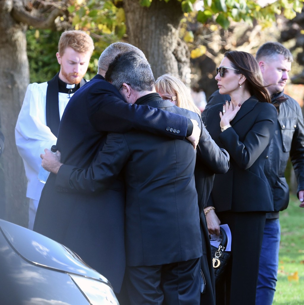 simon cowell hugging liam payne's parents at funeral