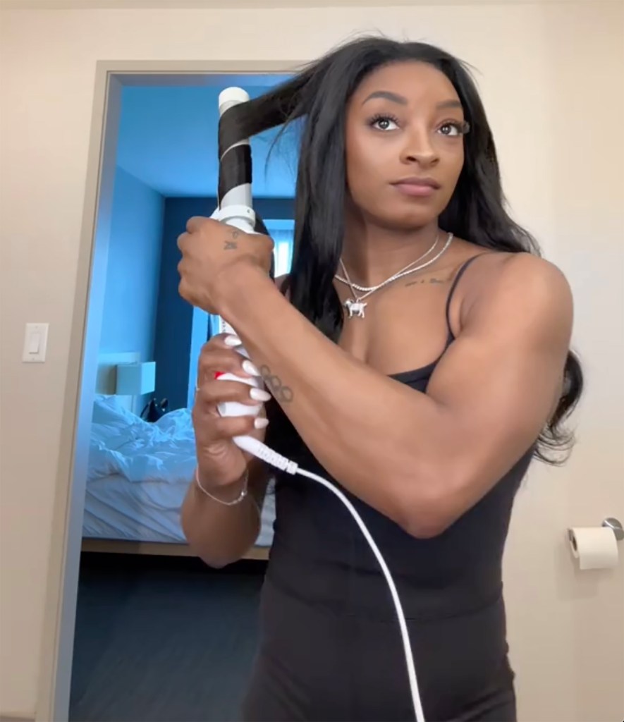 Simone Biles styling her hair