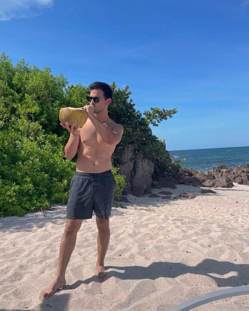 Taylor Lautner poses on a beach.