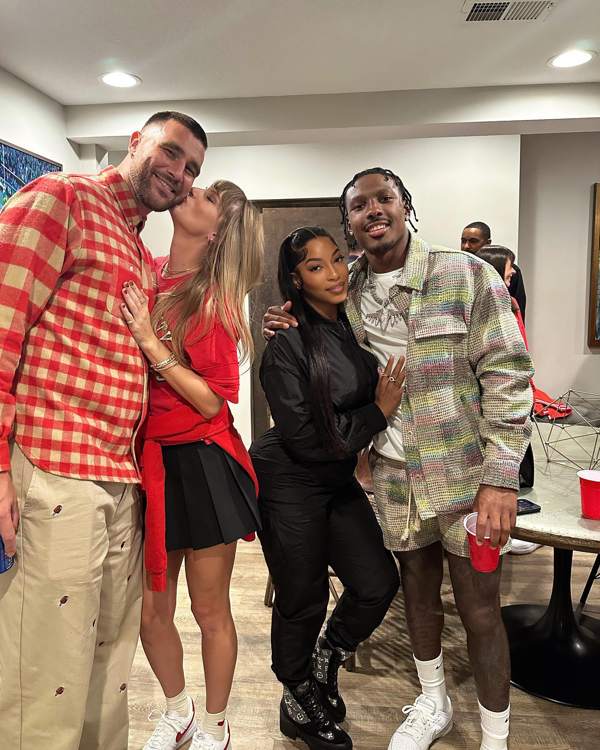 Chariah Gordon and Mecole Hardman with Travis Kelce and Taylor Swift.