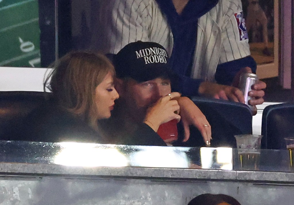 Taylor Swift and Travis Kelce wrapping their arms around each other.