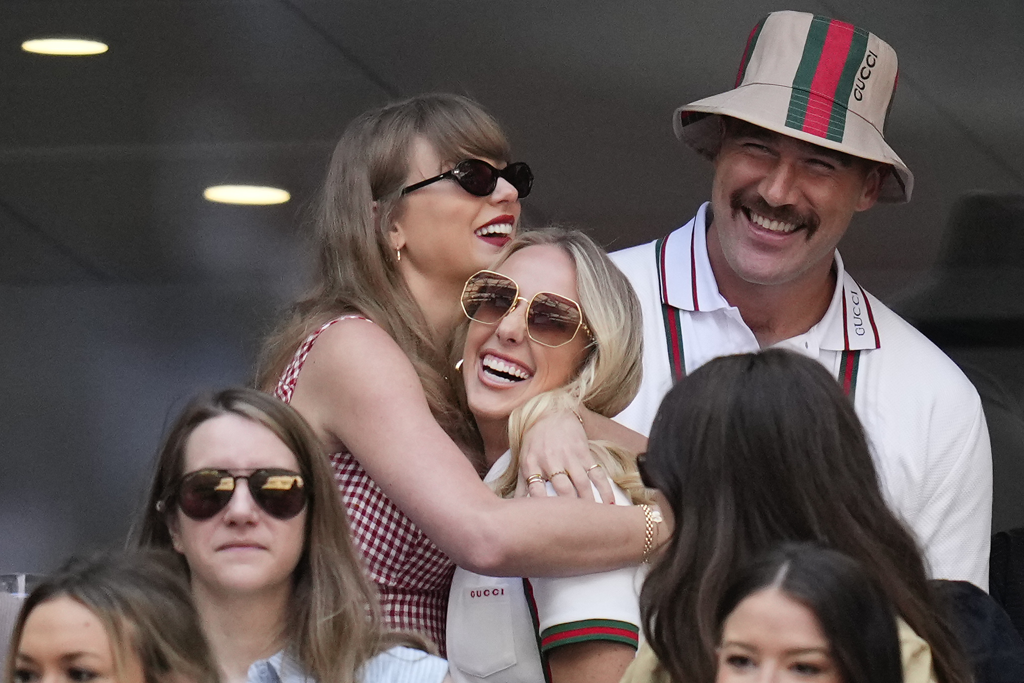 Taylor Swift, Travis Kelce and Brittany Mahomes smiling