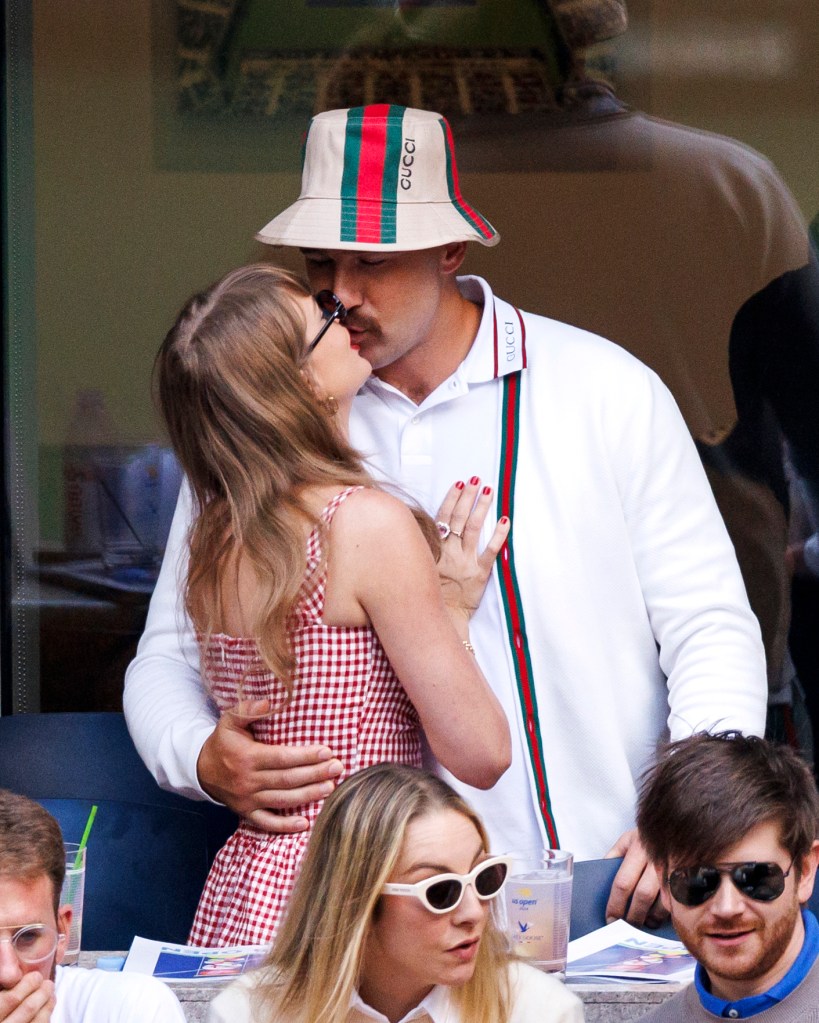 Taylor Swift and Travis Kelce share a kiss