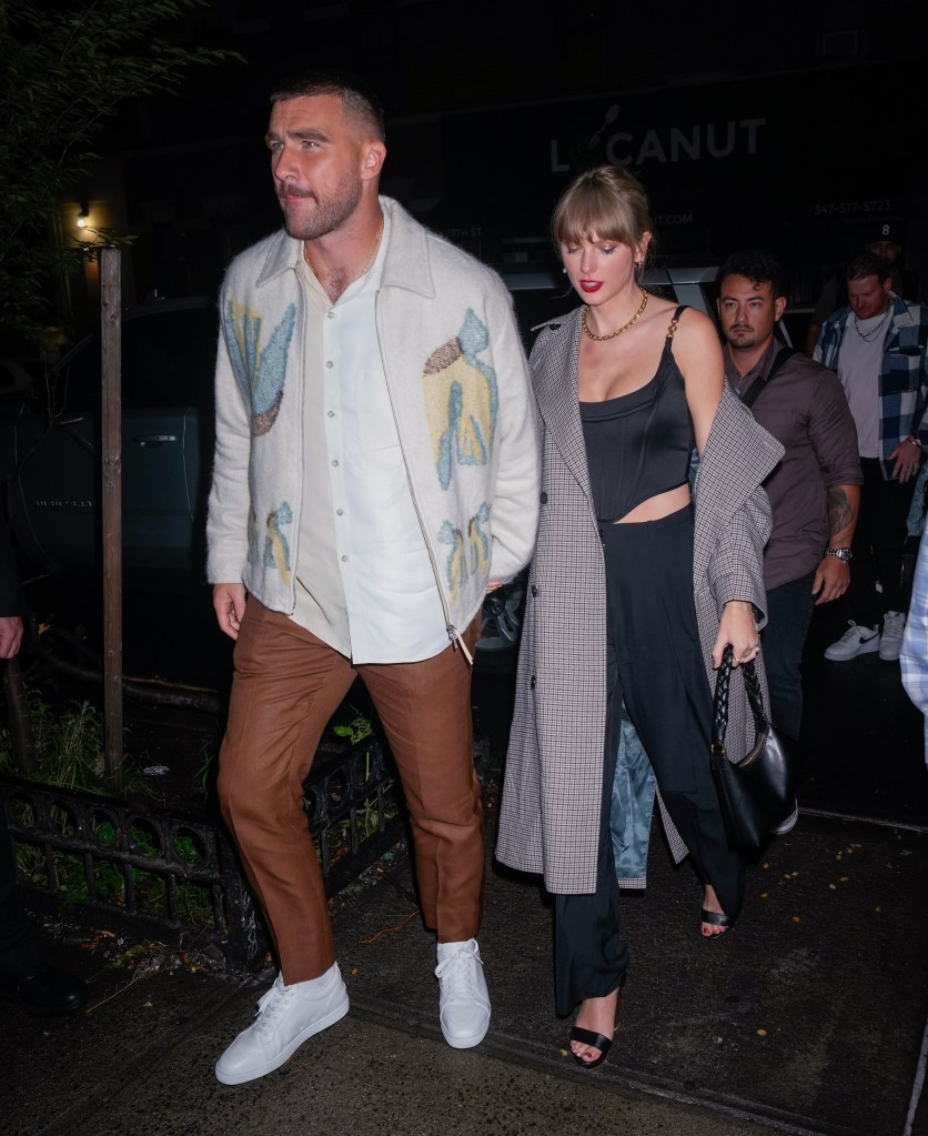 Taylor Swift and Travis Kelce holding hands on a date night.