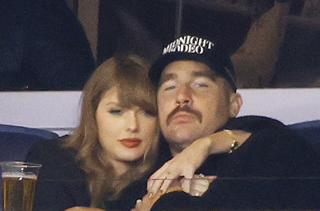 Taylor Swift wraps her arms around Travis Kelce at baseball game