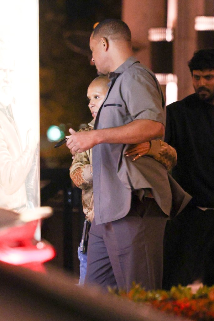 Will Smith and Jada Pinkett Smith hold each other close while leaving dinner in Los Angeles.