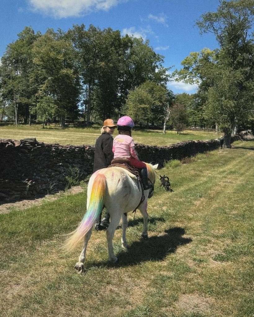 Gigi Hadid walks alongside daughter Khai as she rides on a pony.