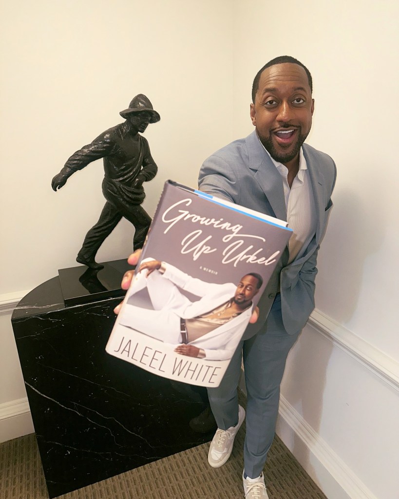 Jaleel White posing with his book "Growing Up Urkel."