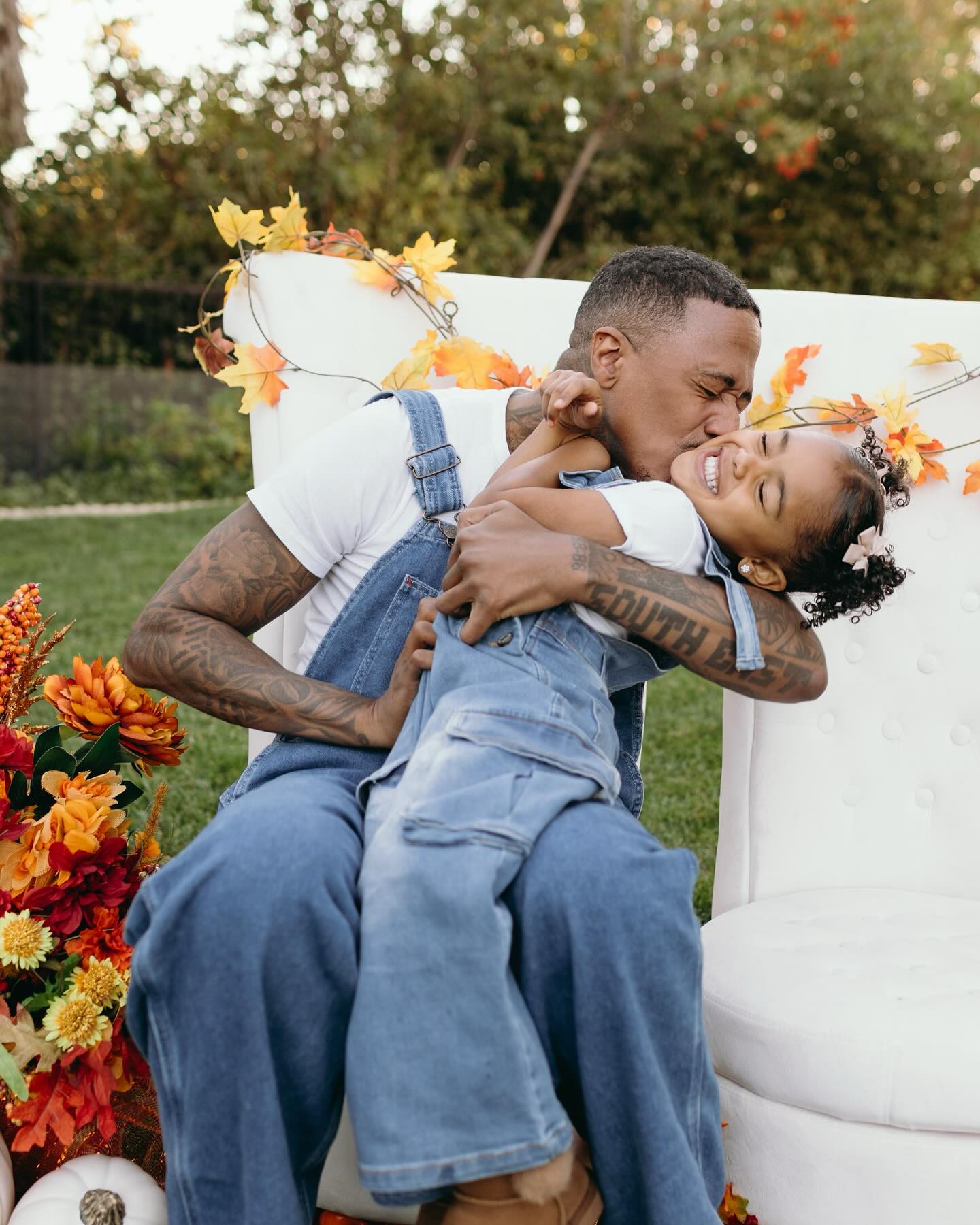 Nick Cannon kisses his daughter during a Thanksgiving photoshoot.