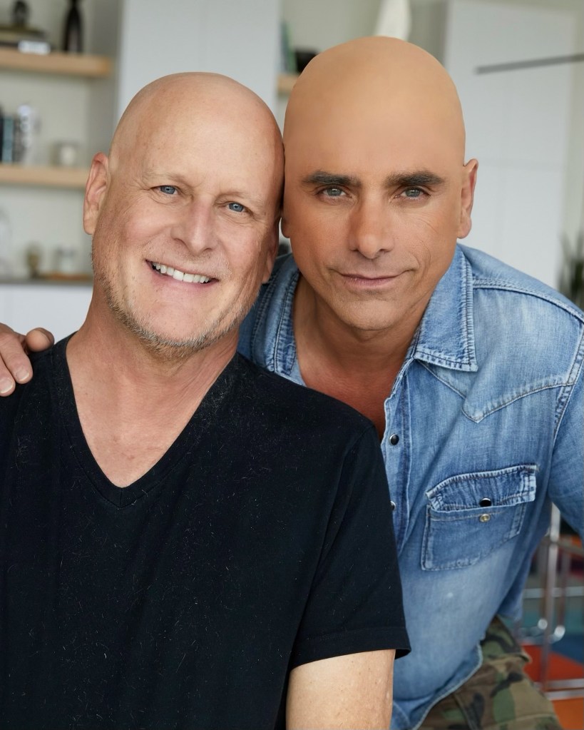 John Stamos poses in a bald cap alongside Dave Coulier on Monday.