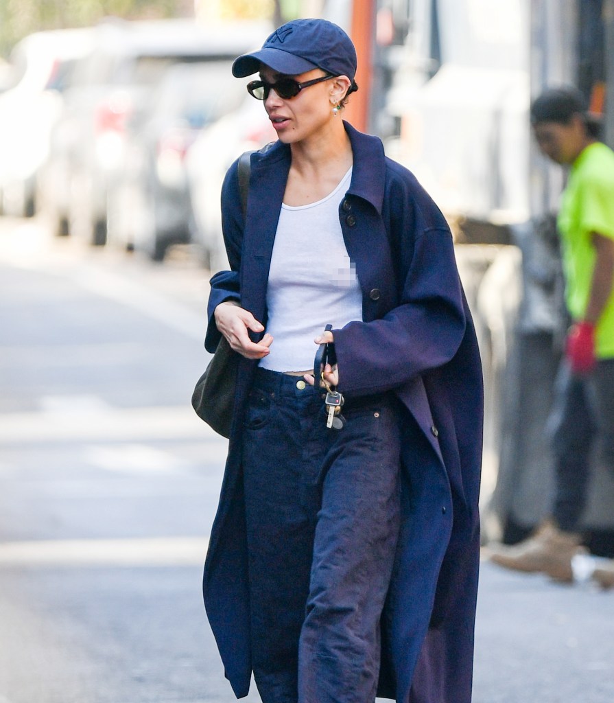 Zoë wearing a long trench coat and sunglasses while out in New York City