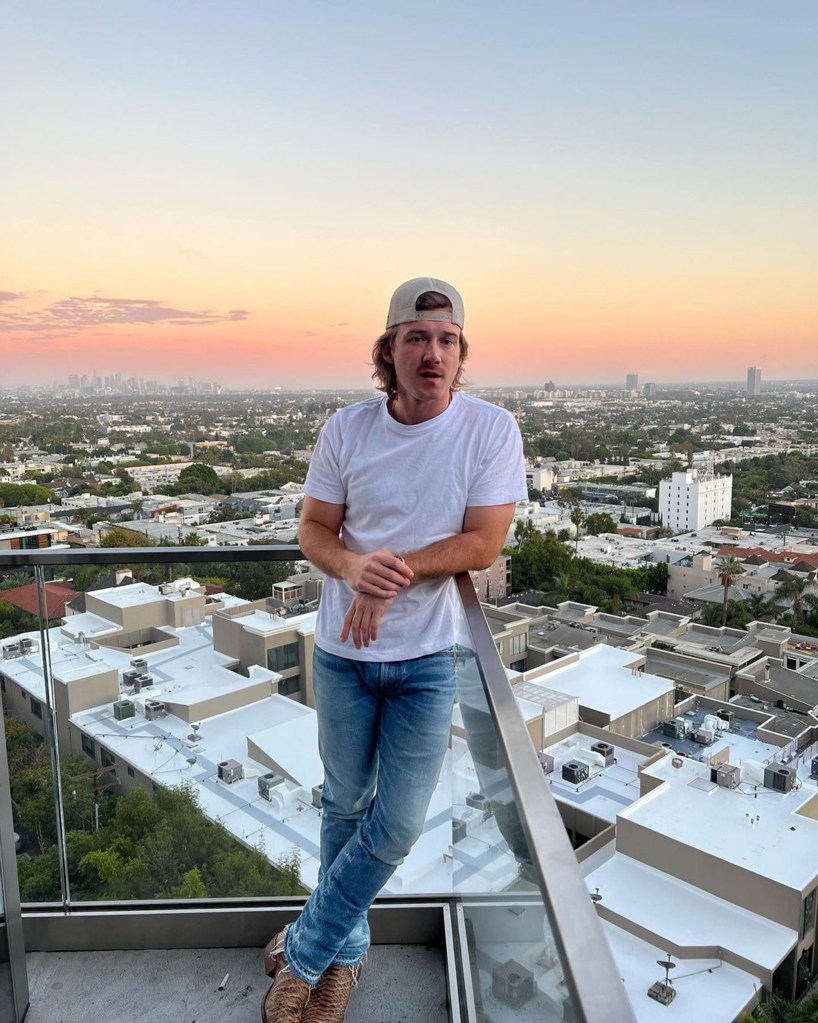 Morgan Wallen poses in front of a sunset