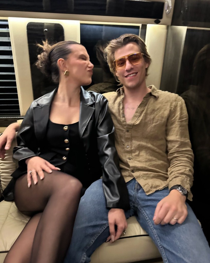 Millie Bobby Brown sitting on a couch with an unidentified man