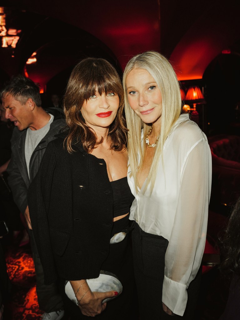 Gwyneth Paltrow and Helena Christensen smiling together at the Violet Grey Residency holiday party hosted by goop and Violet Grey