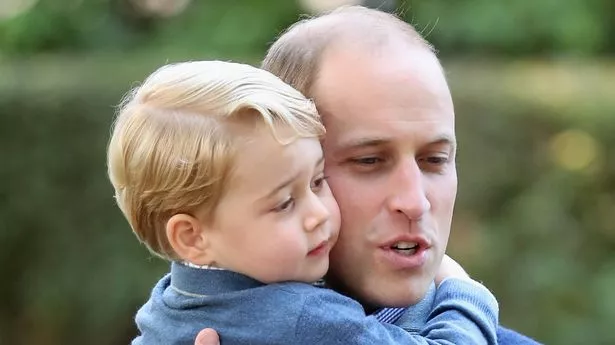 Prince William carrying Prince George