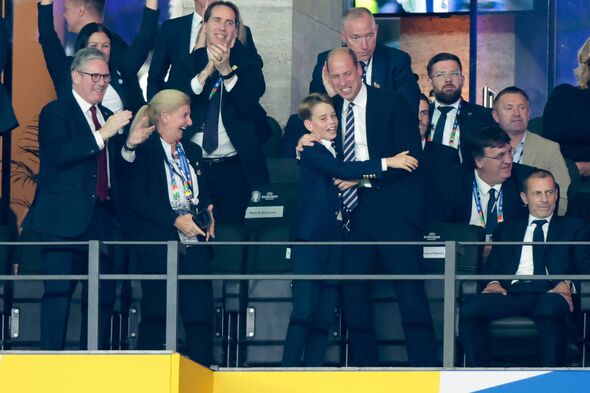 Prince George celebrates goal with Prince William