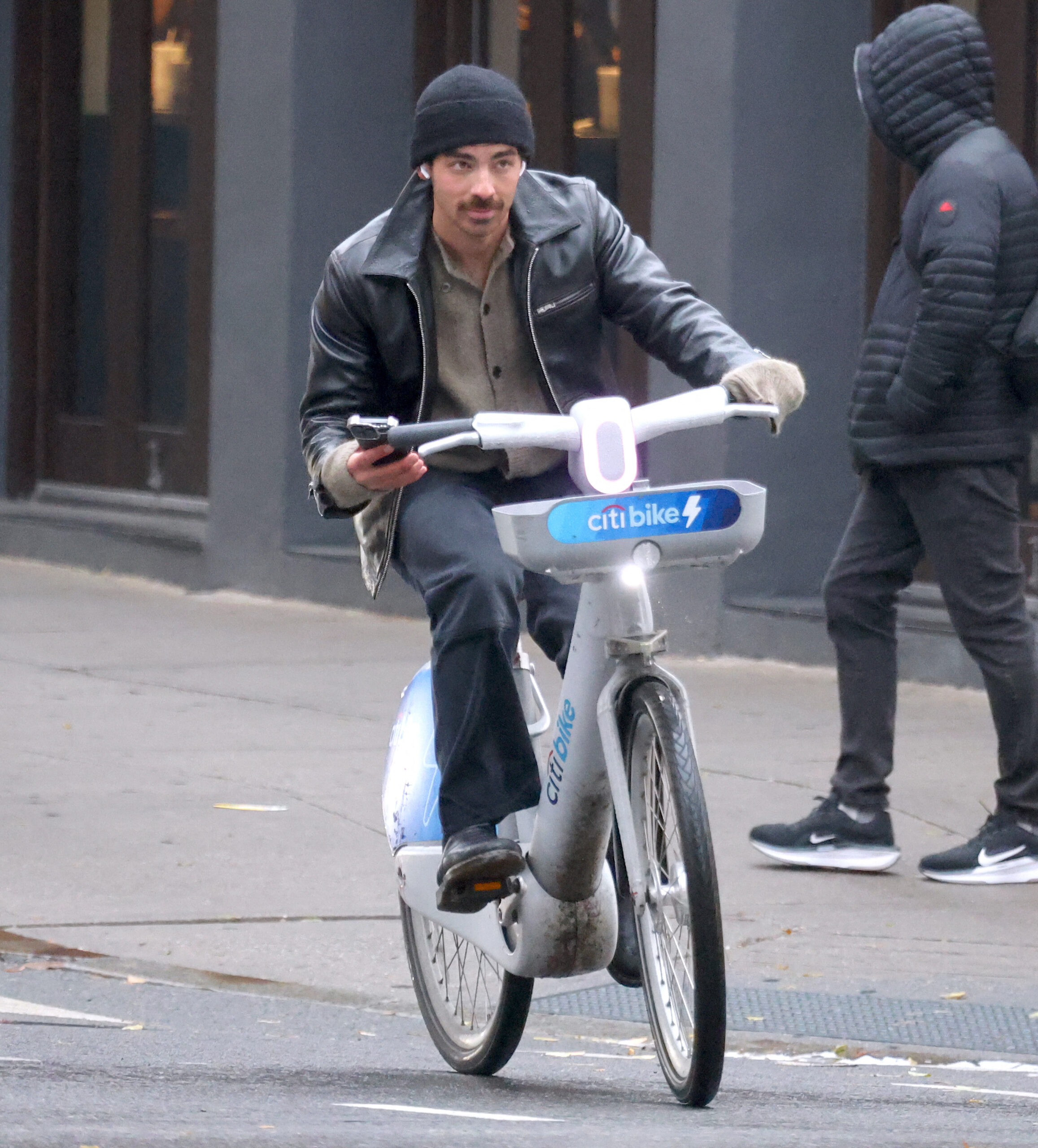 Safety last! Joe Jonas texts and rides in the West Village.